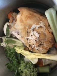 Chicken carcass and veg in large pot.