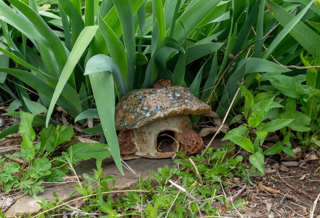 a ceramic toad house shaped like a mushroom